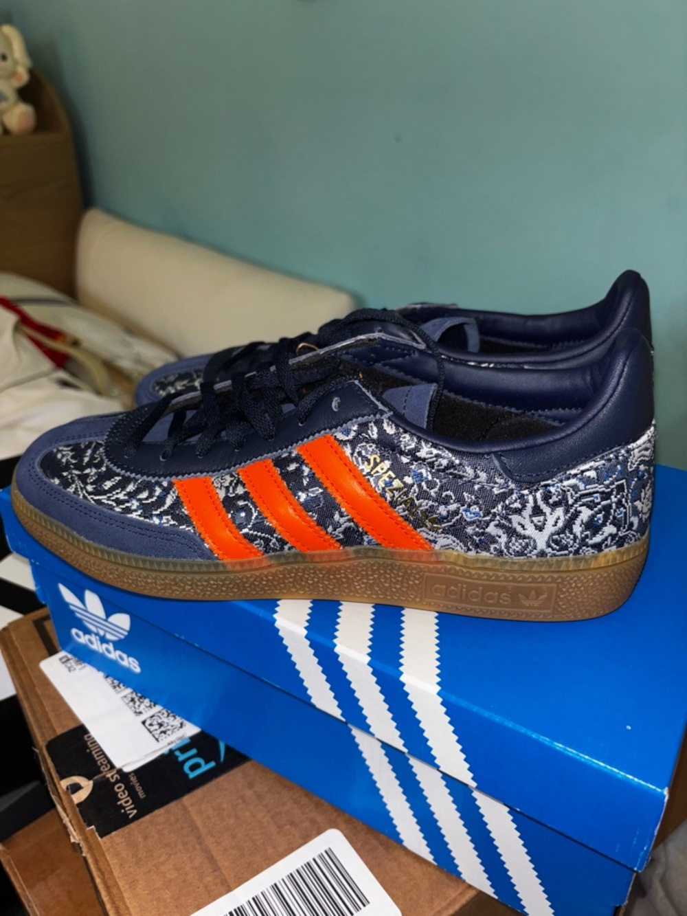 adidas Samba in navy with bright orange stripes and gum sole